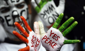 Students display messages painted on their hands and faces during an anti-nuclear demonstration to mark the 62nd anniversary of the bombing of Hiroshima in Mumbai