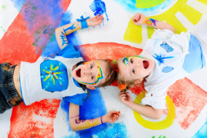 Two beautiful children enjoying their painting. Education.