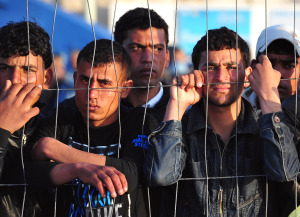 Tunisian migrants wait for the arrival o
